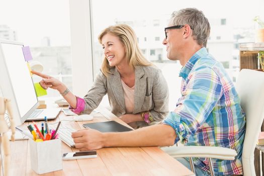 Creative design team working together on computer in the office