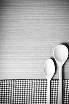 wood spoon and kitchen towel on table black and white color tone style
