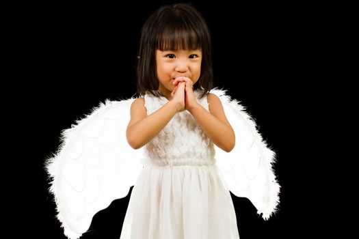 Asian Chinese Little Angel in black background studio shot.