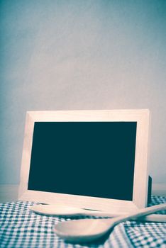 blackboard and wooden spoon on table vintage style