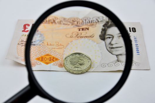 British banknotes and coin view by magnifier