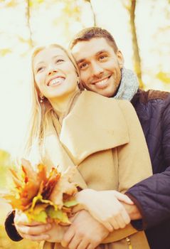 holidays, love, travel, relationship and dating concept - romantic couple in the autumn park