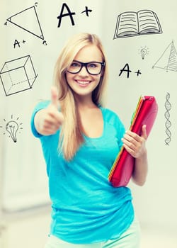 education and school concept - smiling student with folders showing thumbs up