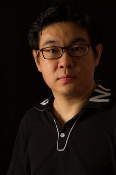 Asian Chinese Guy Portrait in dark background studio shots.