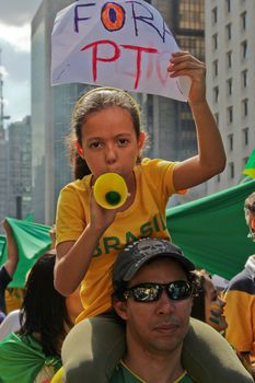 SAO PAULO, BRAZIL August 16, 2015: An unidentified man with a girl with a poster in the protest against federal government corruption in Sao Paulo Brazil.