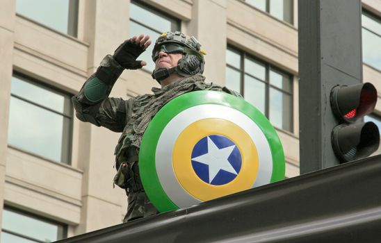 SAO PAULO, BRAZIL August 16, 2015: An unidentified man dressed as a super hero with colors yellow and green in the protest against federal government corruption in Sao Paulo Brazil.