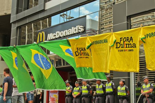 SAO PAULO, BRAZIL August 16, 2015: Flags and T-Shirts to sell in the protest against federal government corruption in Sao Paulo Brazil. Protesters call for the impeachment of President Dilma Rousseff.