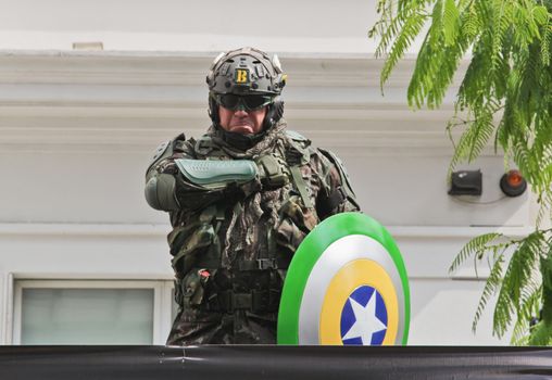 SAO PAULO, BRAZIL August 16, 2015: An unidentified man dressed as a super hero with colors yellow and green in the protest against federal government corruption in Sao Paulo Brazil.