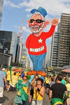 SAO PAULO, BRAZIL August 16 2015: An unidentified group of people with flags and yellow and green clothes in the protest against federal government corruption in Sao Paulo Brazil.