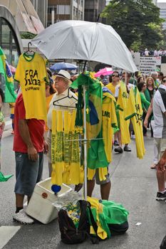 SAO PAULO, BRAZIL August 16, 2015: Flags and T-Shirts to sell in the protest against federal government corruption in Sao Paulo Brazil. Protesters call for the impeachment of President Dilma Rousseff.