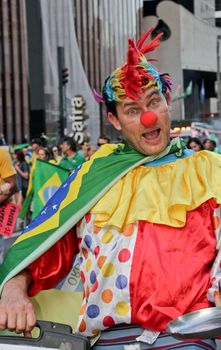 SAO PAULO, BRAZIL August 16, 2015: An unidentified man with clown costume in the protest against federal government corruption in Sao Paulo Brazil. Protesters call for the impeachment of President Dilma Rousseff.