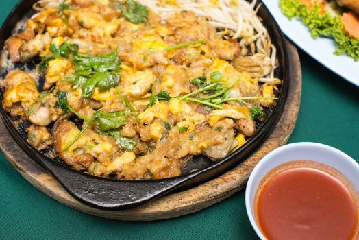 Thai food, fried mussel pancake in hot pan or Oysters on the hot pan