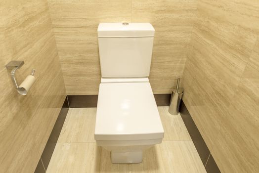 White toilet in the interior of the restroom