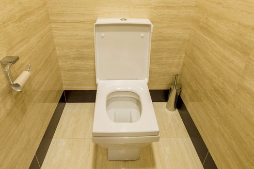 White toilet in the interior of the restroom