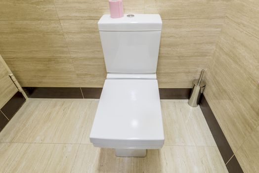 White toilet in the interior of the restroom