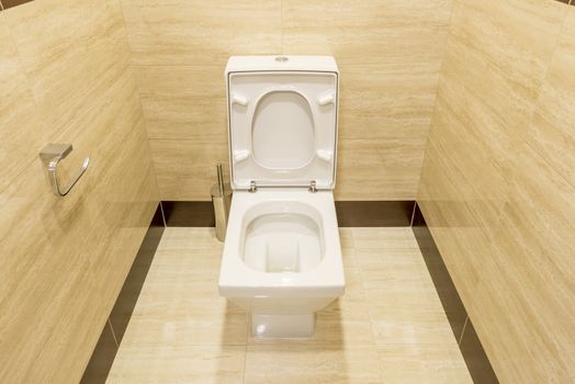 White toilet in the interior of the restroom