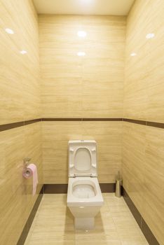 White toilet in the interior of the restroom