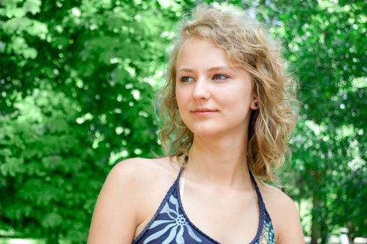 Portrait of young beautiful girl in the park at summer.