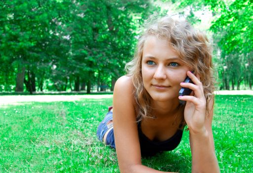 Communication conceptual image. Young beautiful girl talking on a cell phone.