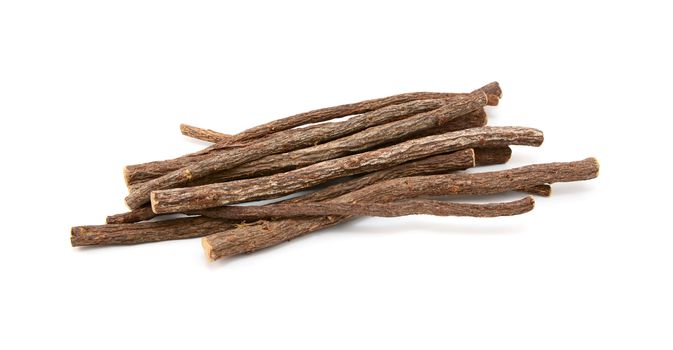 Small pile of liquorice root, isolated on a white background