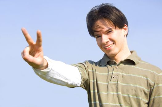 Gesture conceptual image. Teenager giving the victory signs.