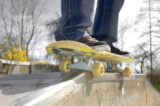 Skateboarder doing a slide. Picture of skateborad.