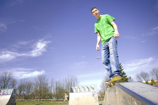 Skateboarder conceptual image. Teenage skateboarder doing a slide.