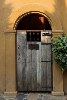 Stucco building with arched and wooden door