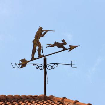 Weather vane with blue sky