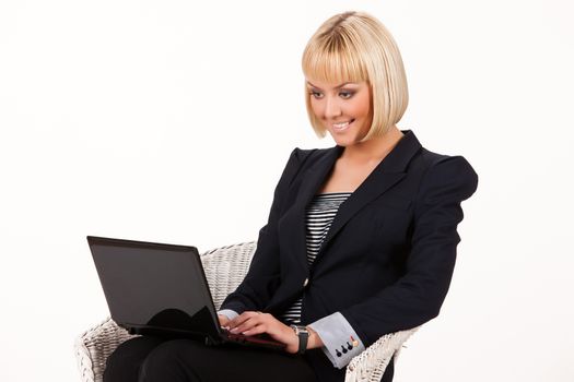 Young blonde woman with computer on a studio isolated background