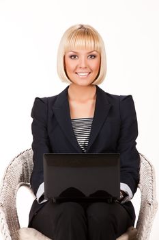 Young blonde woman with computer on a studio isolated background