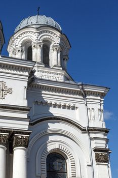Close up view of catholic roman church named St Micheal the Archangel in Kaunas, on clear navy blue sky background.