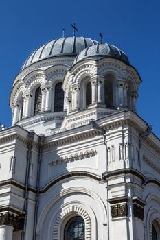 View of catholic roman church named St Micheal the Archangel in Kaunas, on clear navy blue sky background.