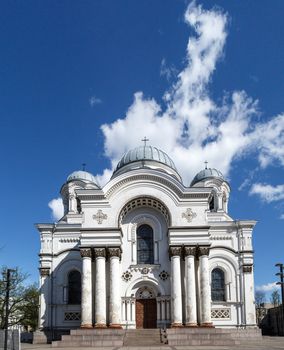 Front view of catholic roman church named St Micheal the Archangel in Kaunas, on cloudy blue sky background.