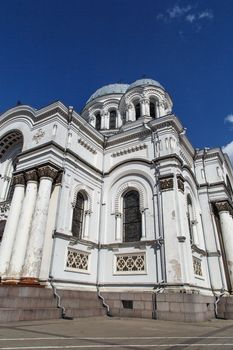 Bottom side view of catholic roman church named St Micheal the Archangel in Kaunas, on clear navy blue sky background.