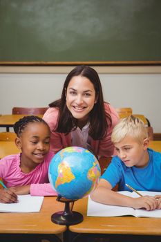 Teacher sitting with her students at the elementary school