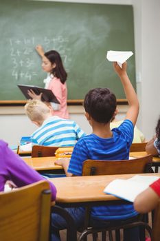 Student about to throw a paper airplane at the elementary school