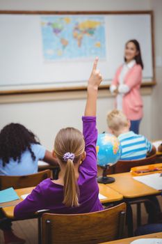 Student raising hand to ask a question at the elementary school