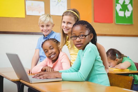 Pupils using a laptop in class at the elementary school