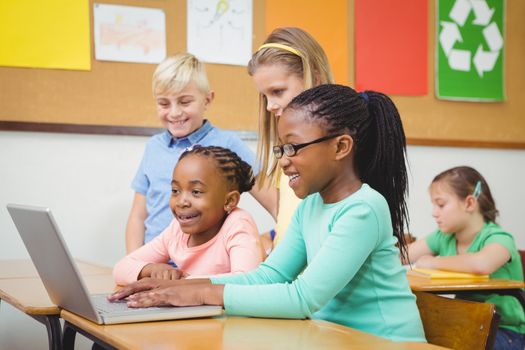 Pupils using a laptop in class at the elementary school