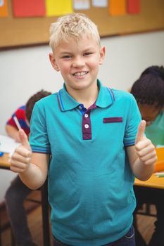 Smiling student with thumbs up at the elementary school