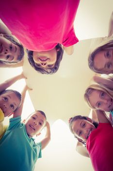 Cute pupils showing large poster on elementary school campus