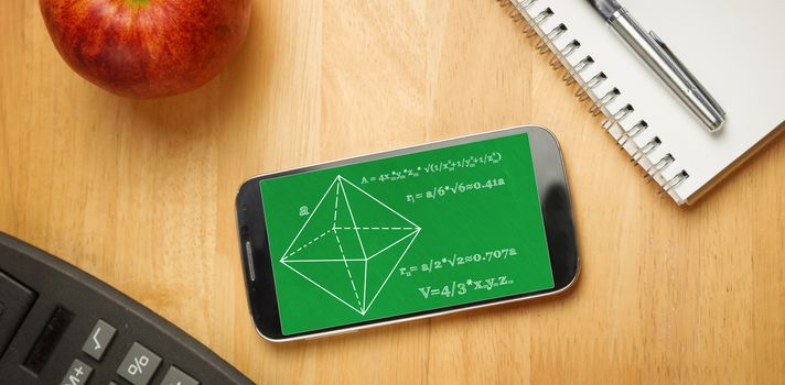 Math problems against smartphone on desk