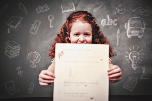 Education doodles against portrait of cute little girl holding paper