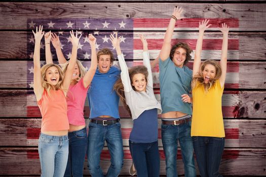 Celebrating friends jumping in the air against composite image of usa national flag