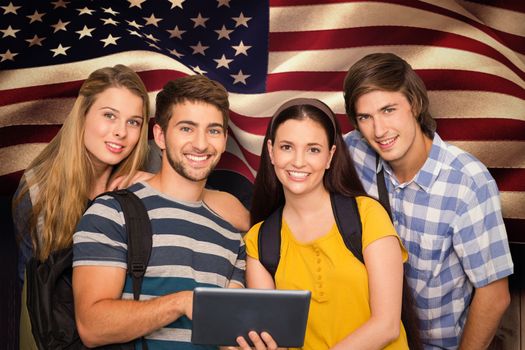 Students using digital tablet at college corridor against composite image of digitally generated united states national flag