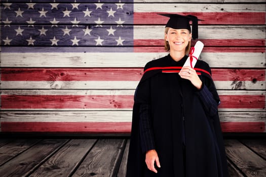 Happy attractive graduate against composite image of usa national flag