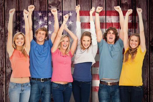 Smiling people raising hands up in the air against composite image of usa national flag