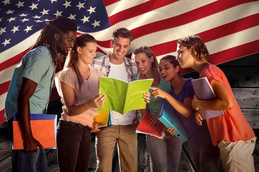 Happy students outside on campus  against composite image of digitally generated united states national flag