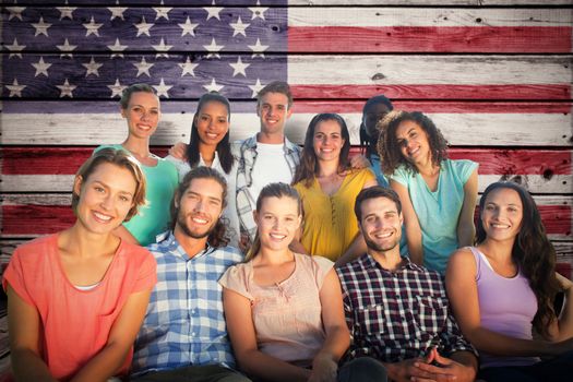 Friends smiling at camera against composite image of usa national flag